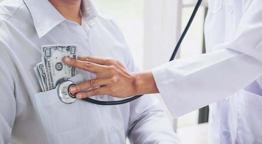 Doctor received corruption money, hand putting money in patient pocket form of dollar banknotes, Bribery and corruption in Health Care Industry.